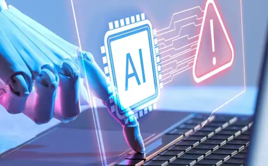 Robotic hand at a keyboard with an AI chip and warning icon